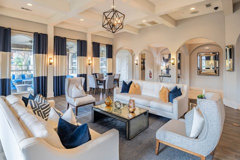 a living room with couches and chairs and a table